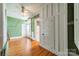 Bright bedroom featuring hardwood floors, vintage-style paneling, multiple doors, and lots of natural light at 8425 E Franklin St, Mount Pleasant, NC 28124