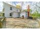 Expansive wooden deck on a white two-story home with a brick chimney and natural surroundings at 8425 E Franklin St, Mount Pleasant, NC 28124