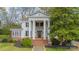 Stately white home featuring grand columns, a brick staircase, and a well-manicured front yard at 8425 E Franklin St, Mount Pleasant, NC 28124