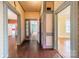 Spacious hallway boasting hardwood floors and beautiful, vintage-style trim on walls and doorway openings at 8425 E Franklin St, Mount Pleasant, NC 28124
