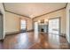 Elegant living room with hardwood floors, fireplace, chandelier, and classic trim at 8425 E Franklin St, Mount Pleasant, NC 28124