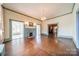 Spacious living room featuring hardwood floors, fireplace, and an ornate chandelier at 8425 E Franklin St, Mount Pleasant, NC 28124