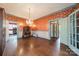 Elegant living room featuring vintage wallpaper, hardwood floors, a vintage chandelier, and radiator at 8425 E Franklin St, Mount Pleasant, NC 28124