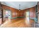 Classic living room with rich wood paneling, hardwood floors, and vintage details throughout at 8425 E Franklin St, Mount Pleasant, NC 28124