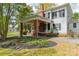Charming side yard features a covered porch with brick pillars and a well-maintained landscape at 8425 E Franklin St, Mount Pleasant, NC 28124
