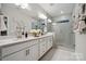 Modern bathroom featuring double vanity sinks, white cabinets and a glass-enclosed shower at 8642 Miles Gap Rd, Indian Land, SC 29707