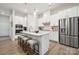 Bright kitchen with stainless steel appliances, white cabinets, and center island with bar stool seating at 8642 Miles Gap Rd, Indian Land, SC 29707