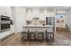 Bright kitchen with white cabinets, stainless appliances, and a center island with seating at 8642 Miles Gap Rd, Indian Land, SC 29707