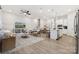 Open-concept living room with white walls, a ceiling fan, and stylish furnishings, creating an inviting space at 8642 Miles Gap Rd, Indian Land, SC 29707