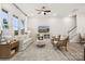 Bright living room featuring large windows, neutral tones, and comfortable seating arrangement for relaxation at 8642 Miles Gap Rd, Indian Land, SC 29707