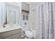 Charming bathroom with tub shower combo and gray vanity with sink at 8801 Oldenburg Dr, Mount Pleasant, NC 28124