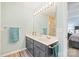 Bright bathroom featuring double sink vanity, large mirror, and tiled shower at 8801 Oldenburg Dr, Mount Pleasant, NC 28124