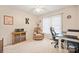 Neutral bedroom with natural light, featuring chair and desk at 8801 Oldenburg Dr, Mount Pleasant, NC 28124