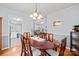 Elegant dining room featuring a wooden table with seating for six with views into other rooms at 8801 Oldenburg Dr, Mount Pleasant, NC 28124