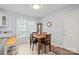 Cozy dining area features a wooden table, four chairs, and natural light from a large window at 8801 Oldenburg Dr, Mount Pleasant, NC 28124
