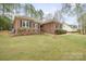 A charming brick home boasting meticulously maintained landscaping and a lush green lawn at 8801 Oldenburg Dr, Mount Pleasant, NC 28124