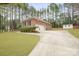 Well-maintained brick home with long driveway, two car garage and manicured landscaping at 8801 Oldenburg Dr, Mount Pleasant, NC 28124