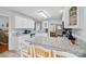 Bright kitchen features white cabinets, granite countertops, and a breakfast bar with seating at 8801 Oldenburg Dr, Mount Pleasant, NC 28124