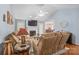 Open-concept living room with hardwood floors, fireplace and access to dining area at 8801 Oldenburg Dr, Mount Pleasant, NC 28124