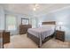 Spacious main bedroom features a tray ceiling, two windows and neutral decor at 8801 Oldenburg Dr, Mount Pleasant, NC 28124