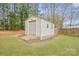 Outbuilding or shed with roll up door, providing extra storage or workshop space at 8801 Oldenburg Dr, Mount Pleasant, NC 28124
