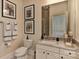 Well-lit bathroom featuring marble countertops, vanity and framed prints at 9703 Cotton Stand Rd, Charlotte, NC 28277