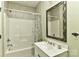 Full bathroom with tub/shower combination and large vanity mirror at 9703 Cotton Stand Rd, Charlotte, NC 28277