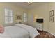 Bright bedroom showcasing windows, ceiling fan, and hardwood floors at 9703 Cotton Stand Rd, Charlotte, NC 28277