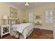 Cozy bedroom with hardwood floors, natural light, ceiling fan and classic decor at 9703 Cotton Stand Rd, Charlotte, NC 28277
