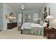 Cozy bedroom features a four poster bed, soft blue walls, and classic decor at 9703 Cotton Stand Rd, Charlotte, NC 28277
