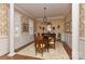 Formal dining room with classic wallpaper, chandelier, and a dining table, perfect for hosting elegant dinners at 9703 Cotton Stand Rd, Charlotte, NC 28277
