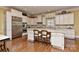 A gourmet kitchen with marble counters, stainless steel appliances, and a large central island at 9703 Cotton Stand Rd, Charlotte, NC 28277
