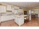 Bright, spacious kitchen with a center island, stainless appliances, and hardwood flooring at 9703 Cotton Stand Rd, Charlotte, NC 28277
