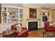 Cozy living room with a fireplace, built-in shelving, and comfortable seating, creating a warm and inviting atmosphere at 9703 Cotton Stand Rd, Charlotte, NC 28277