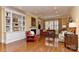 Inviting living room with built-in bookshelves, a fireplace, and hardwood floors, ideal for relaxation and entertaining at 9703 Cotton Stand Rd, Charlotte, NC 28277