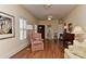 Comfortable living room with hardwood flooring, natural light, and a mix of seating options at 9703 Cotton Stand Rd, Charlotte, NC 28277