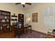 Elegant office features custom bookshelves, hardwood floors, ceiling fan and natural light at 9703 Cotton Stand Rd, Charlotte, NC 28277