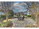 Backyard patio with outdoor dining set and manicured landscaping at 9703 Cotton Stand Rd, Charlotte, NC 28277