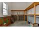 Unfinished basement storage area with built-in wooden shelving at 9703 Cotton Stand Rd, Charlotte, NC 28277