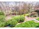 Scenic backyard featuring manicured landscaping and mature trees creating a private outdoor oasis at 1027 Brookline Dr, Huntersville, NC 28078