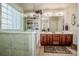 Bright bathroom featuring a soaking tub, glass shower, dual vanity, and ample counter space at 1027 Brookline Dr, Huntersville, NC 28078