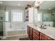 Bright bathroom featuring a soaking tub, glass shower, dual vanity, and ample counter space at 1027 Brookline Dr, Huntersville, NC 28078