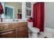 This bathroom features a combination shower-tub, cherry vanity, and updated fixtures at 1027 Brookline Dr, Huntersville, NC 28078