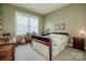 Cozy bedroom with large window, neutral color palette, and vintage furniture at 1027 Brookline Dr, Huntersville, NC 28078