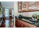 Butler pantry with granite countertop and wood cabinets, with glimpses into another room at 1027 Brookline Dr, Huntersville, NC 28078