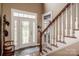 Inviting foyer with hardwood floors, staircase, and a stained-glass front door at 1027 Brookline Dr, Huntersville, NC 28078