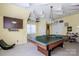 Game room with billiard table, sports decor and a decorative stained glass light fixture at 1027 Brookline Dr, Huntersville, NC 28078