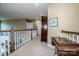 Well-lit upstairs hallway with wooden railing and trim, and a view to the lower level at 1027 Brookline Dr, Huntersville, NC 28078