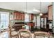 This kitchen features granite counters, dark wood cabinets, a large island, and stainless steel appliances at 1027 Brookline Dr, Huntersville, NC 28078