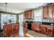 Kitchen featuring granite counters, dark wood cabinets, recessed lighting, and hardwood floors at 1027 Brookline Dr, Huntersville, NC 28078